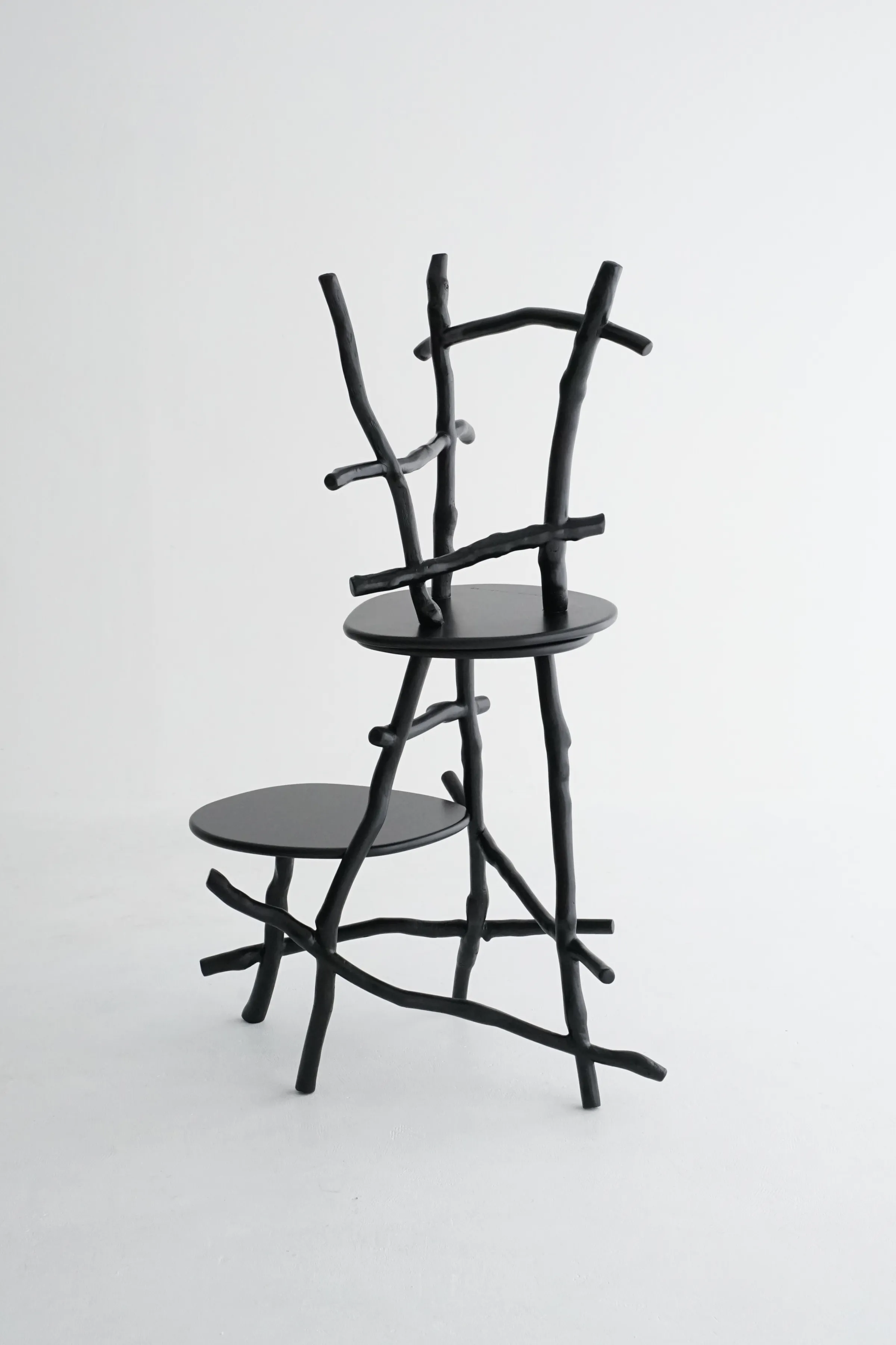Uneri stool carried by figure in motion showing scale and sculptural form
